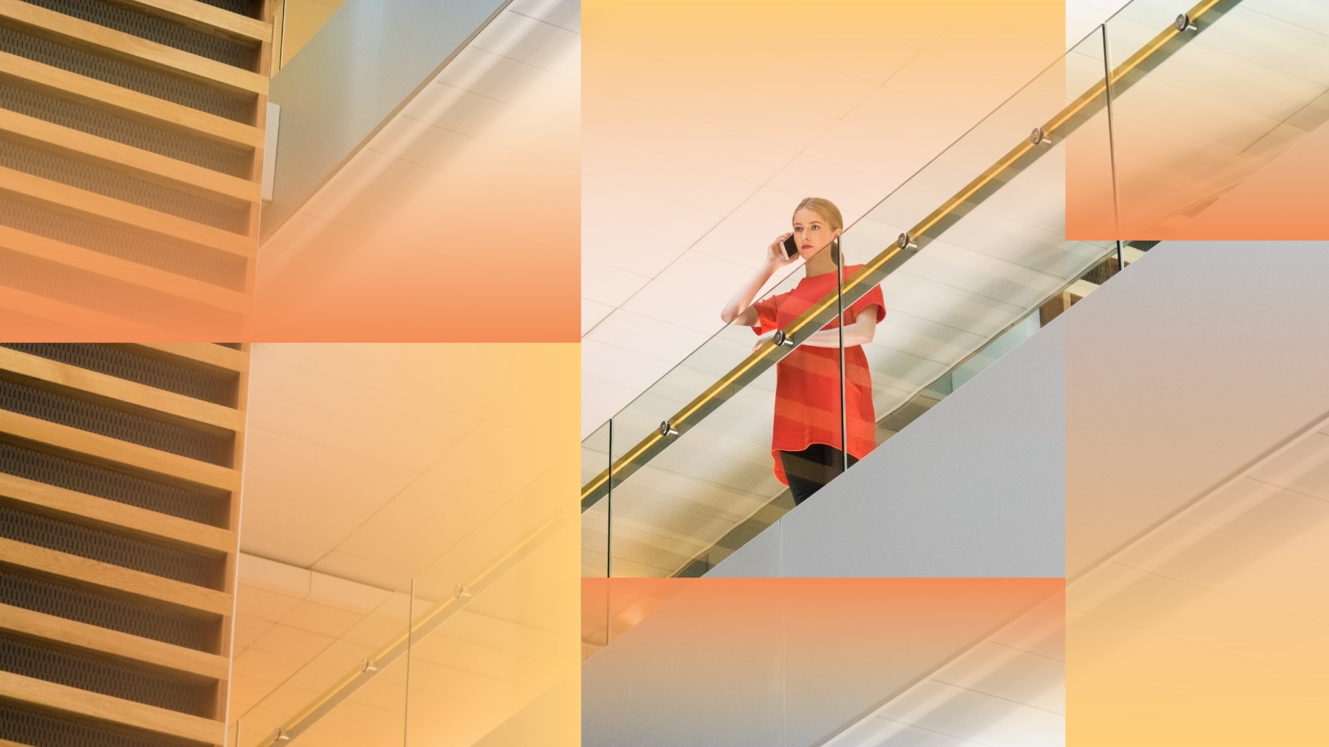 Woman speaks on a phone while standing on an office balcony